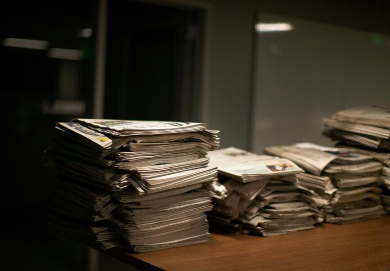Copies of The Oregonian newspaper are stacked inside The Oregonian/OregonLive's newsroom on Dec. 16, 2020.